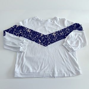 Waffle knit white fabric with chest V stripe in true cheetah print color.